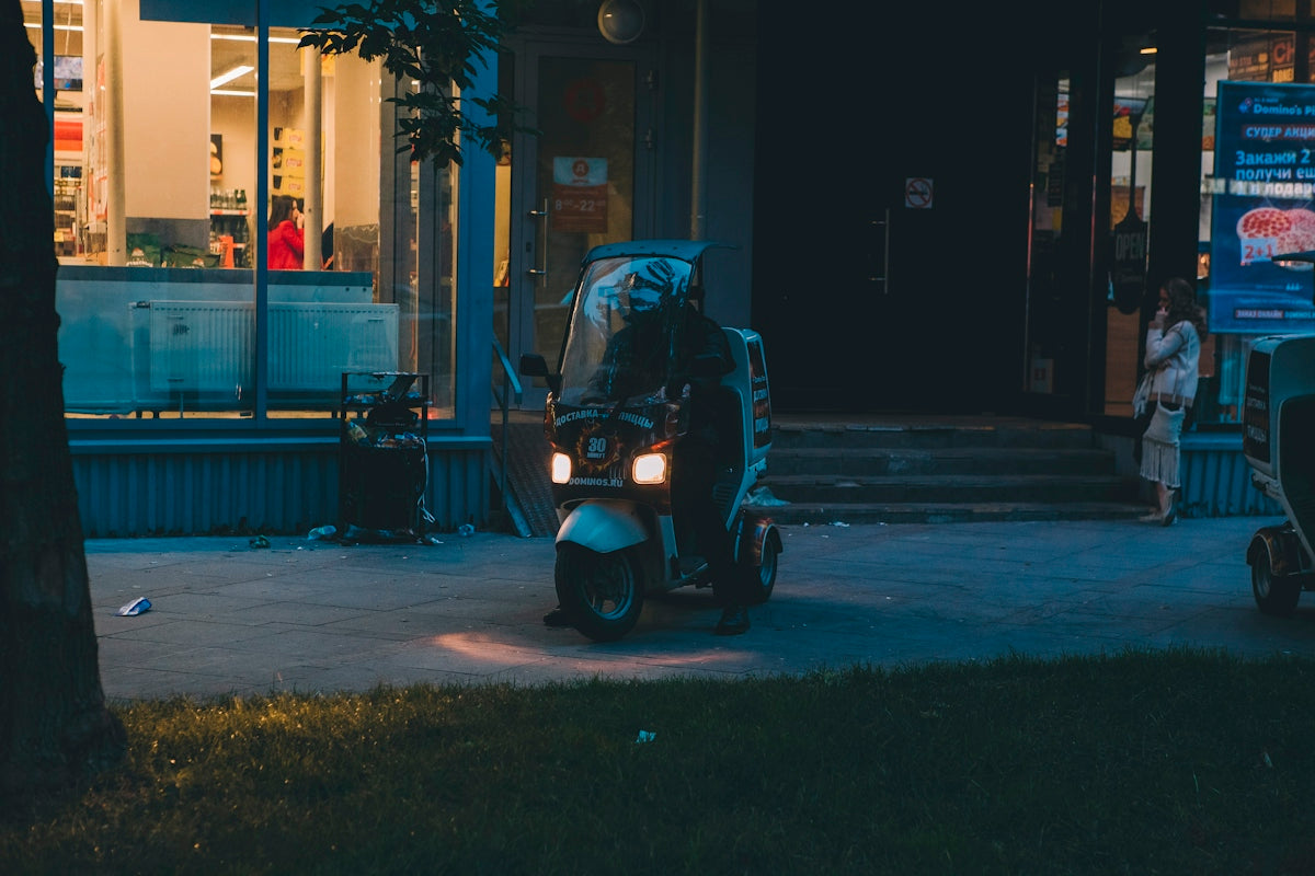 person riding motorcycle near building