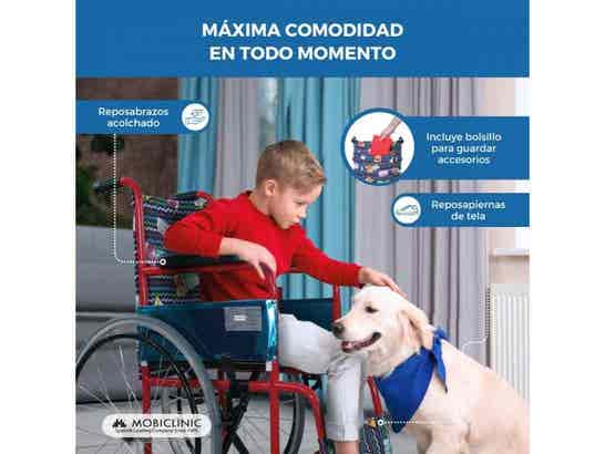 Bambino sulla sedia a rotelle per bambini colorata accarezza un cane, mostrando comodità e funzionalità.